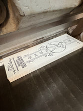Load image into Gallery viewer, oh my gosh, here we see a tyov bookmark in the process of being cut! A naked lady with a shovel is printed on the paper.